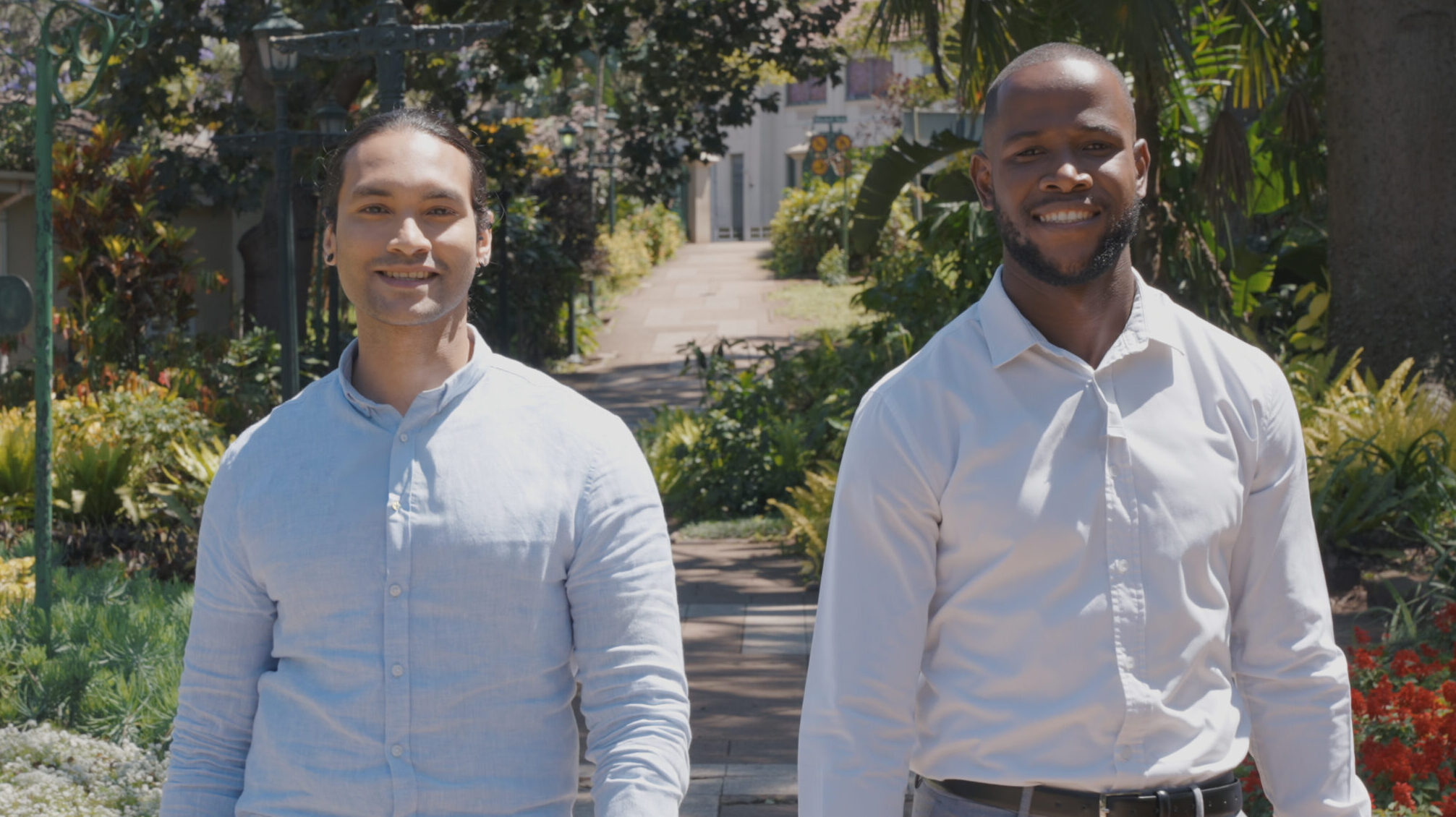 Two tv presenters walking through Mitchell Park Durban